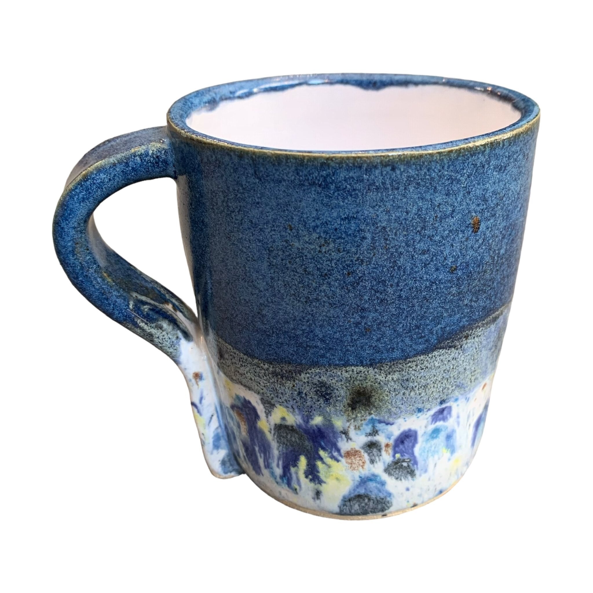 A navy mug with a shoreline pattern around the bottom half.