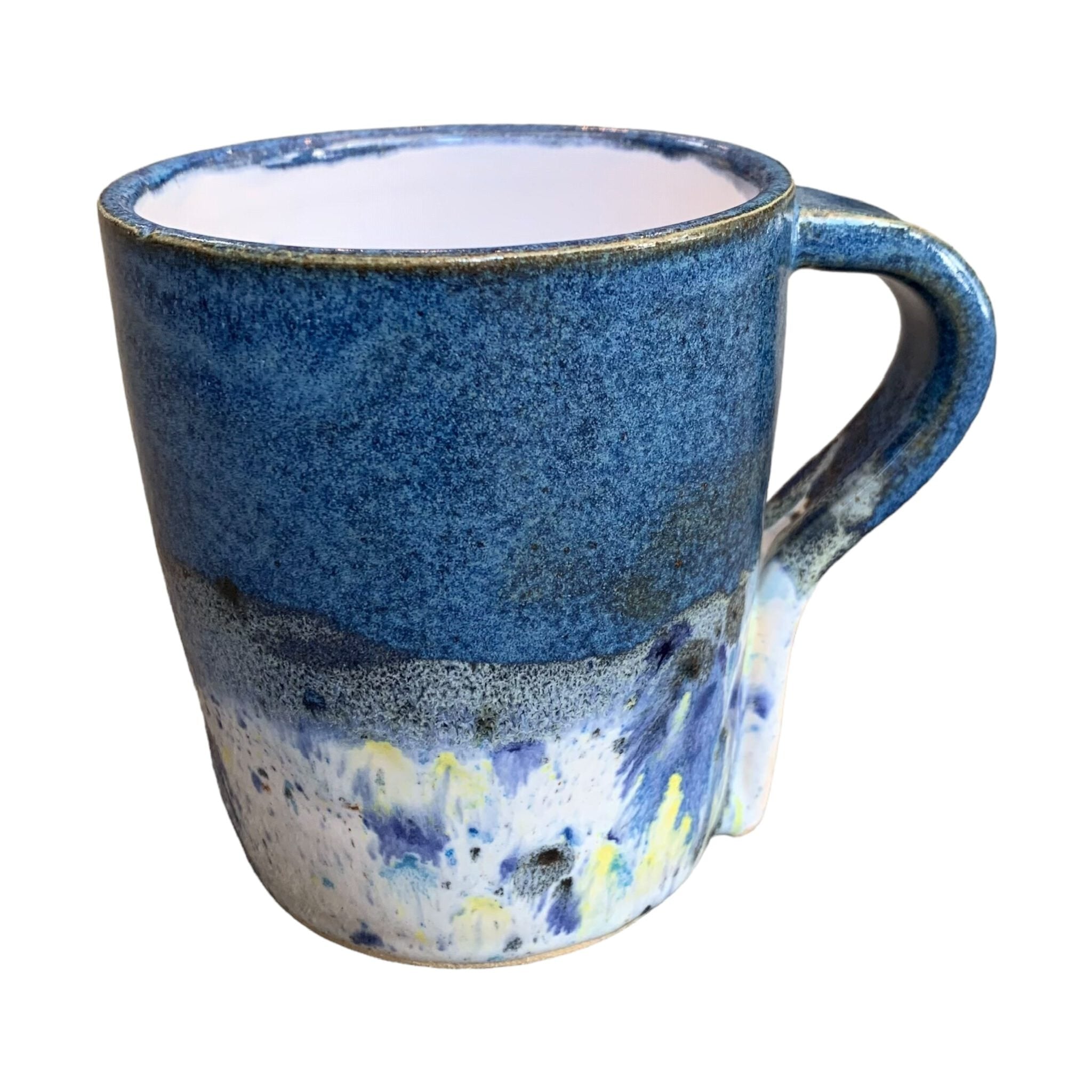 A navy mug with a shoreline pattern around the bottom half.