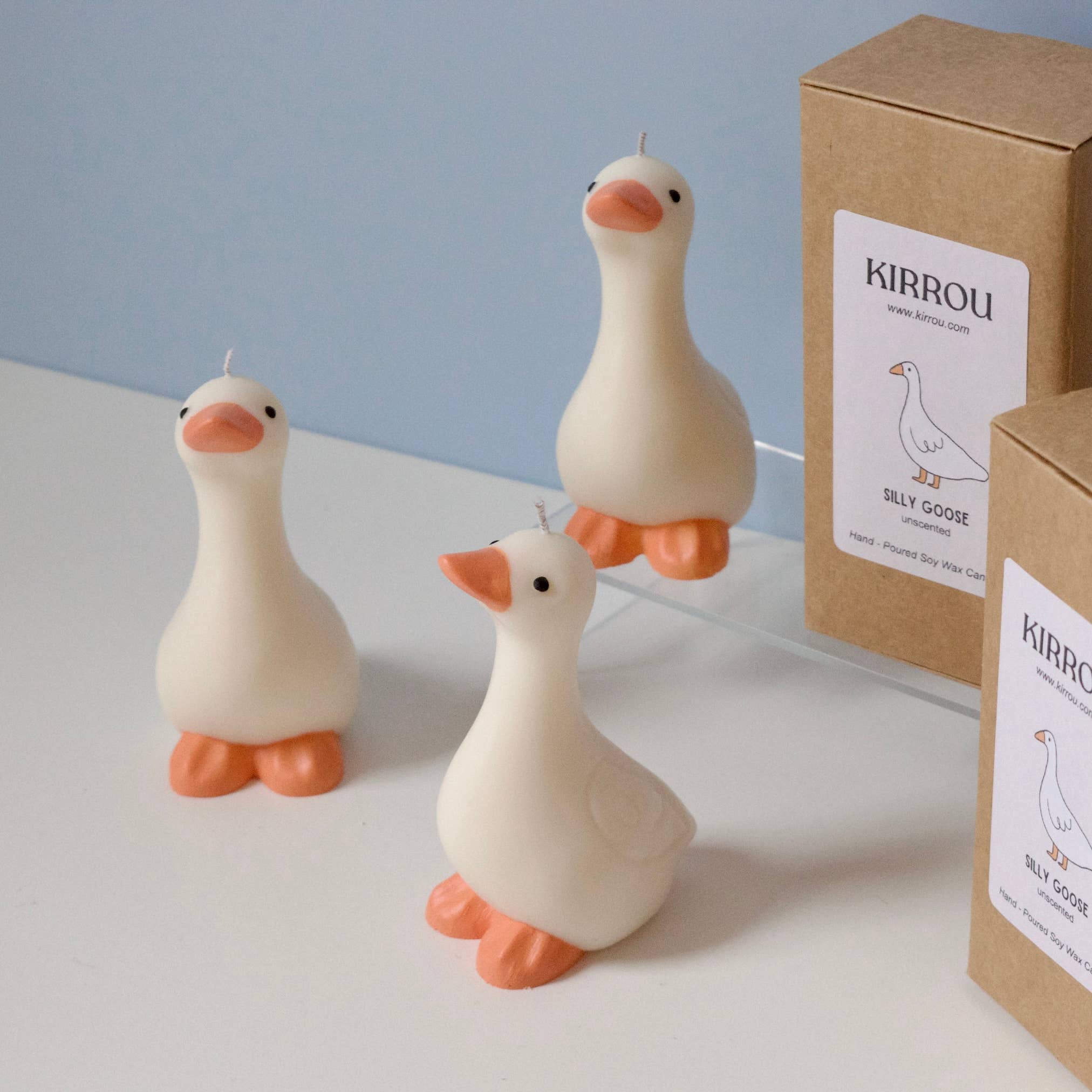 Three duck-shaped candles with boxes labeled 'KIRROU' on a light background.