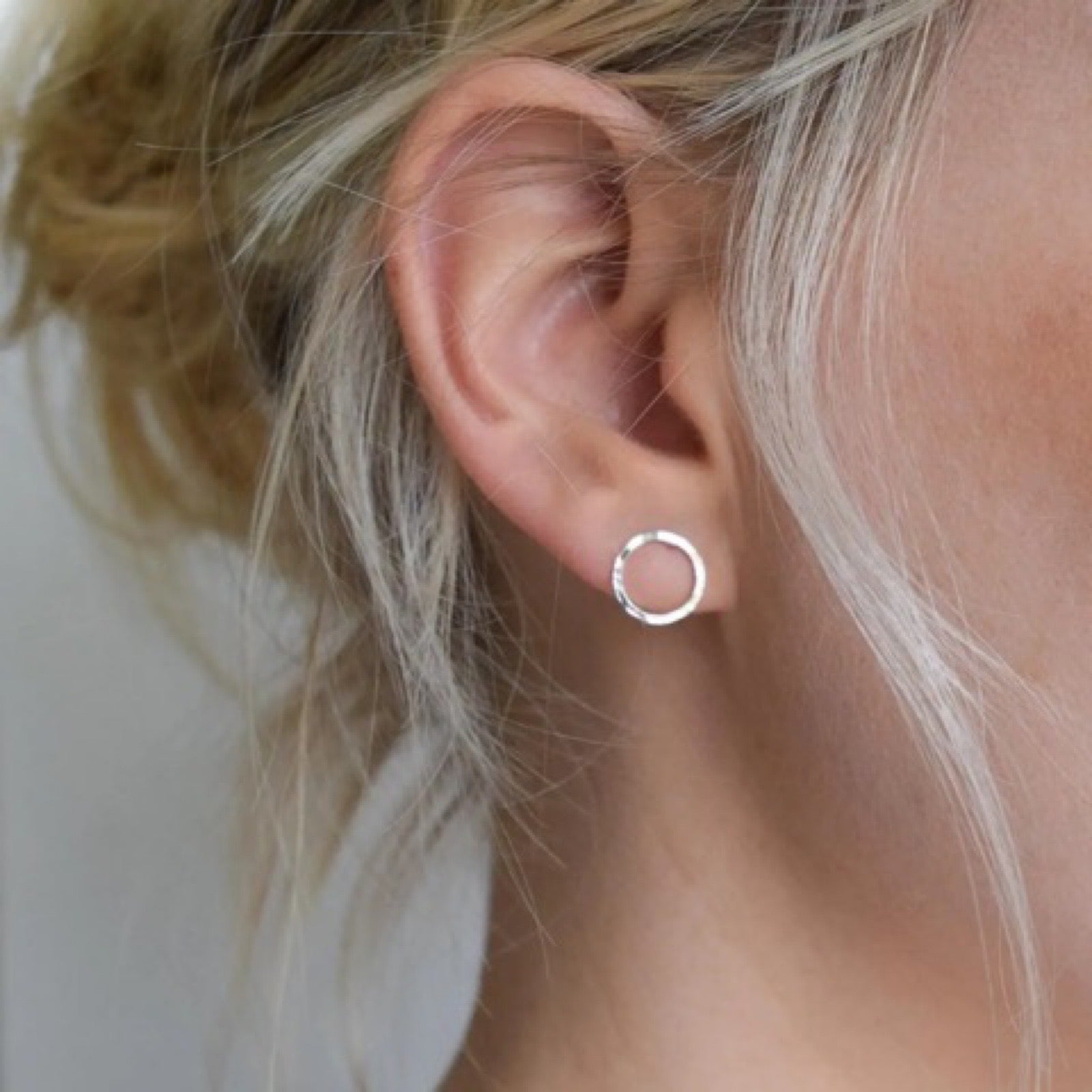 Handcrafted, hammered, circular sterling silver earrings.