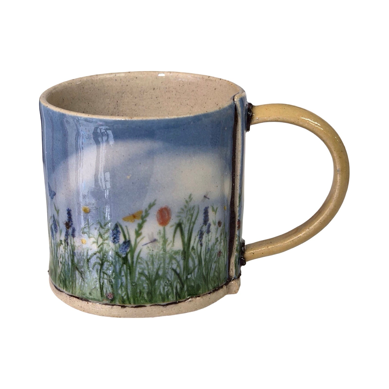 Ceramic mug with a nature-themed design on a white background.