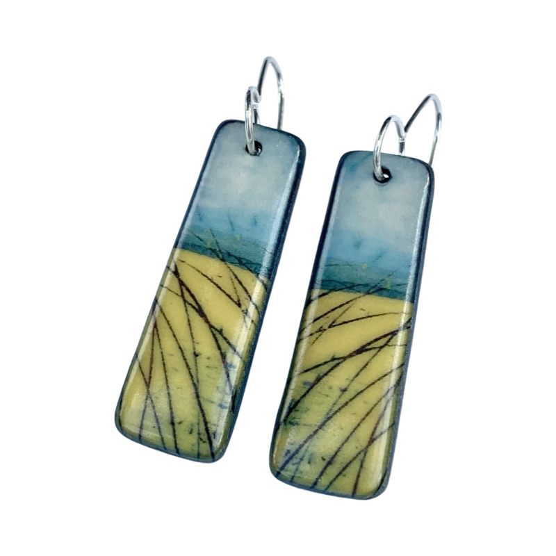 These porcelain drop earrings are made from black porcelain casting slip layered with a white decorating slip and a ceramic decal.