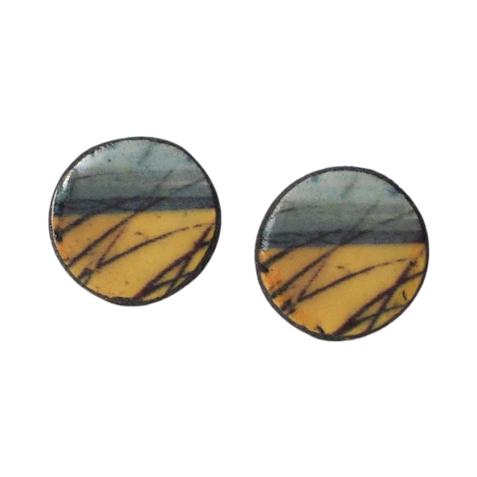 These porcelain round stud earrings are made from black porcelain casting slip layered with a white decorating slip and a ceramic decal.
