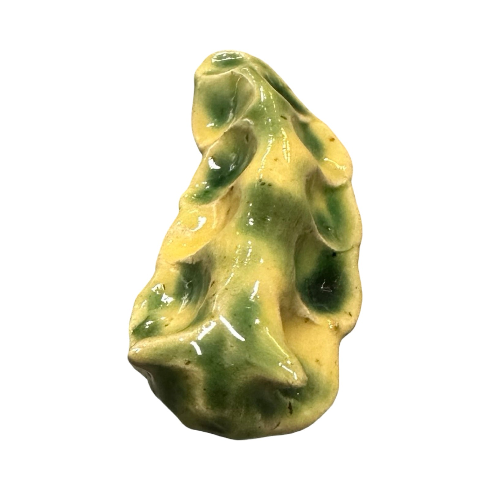 Green ceramic slug-shaped ornament on a white background.