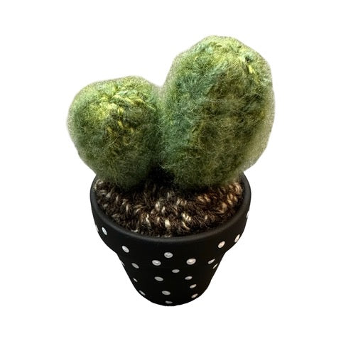 Handmade double crochet cactus in a black and white spotty painted terracotta pot.