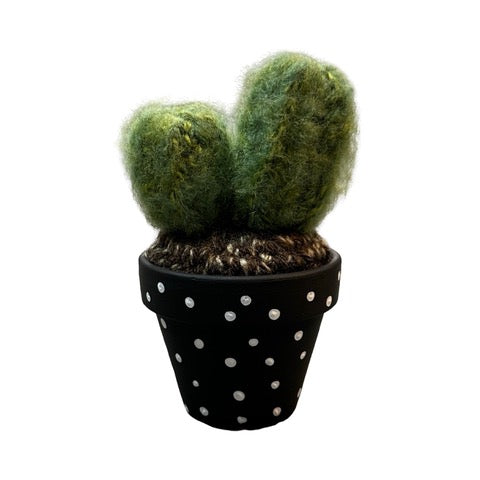 Handmade double crochet cactus in a black and white spotty painted terracotta pot.