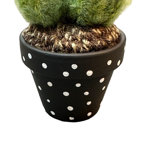 Handmade double crochet cactus in a black and white spotty painted terracotta pot.