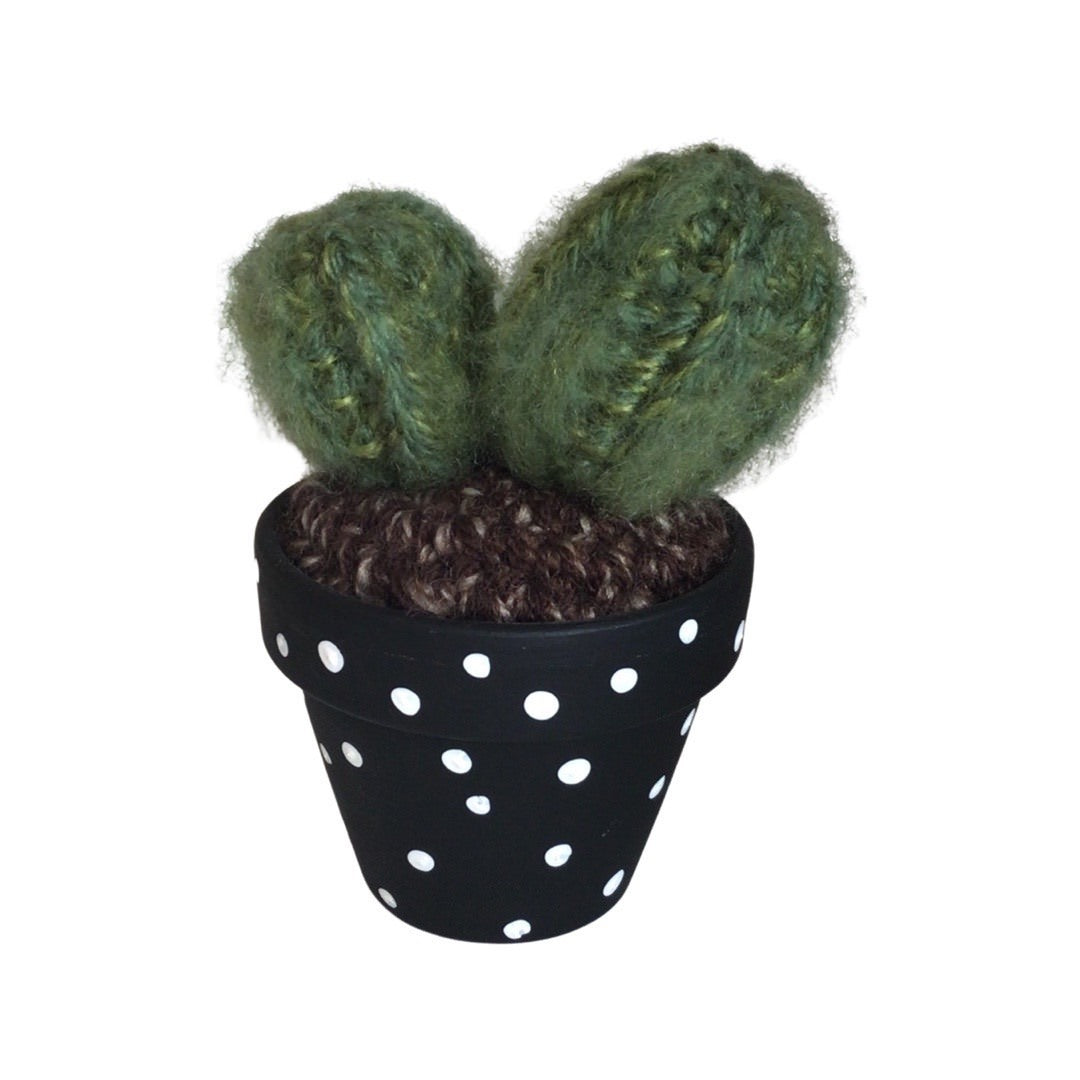 Handmade double crochet cactus in a black and white spotty painted terracotta pot.