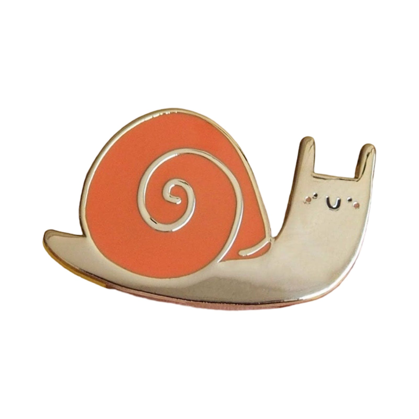Cute snail-shaped enamel pin with a smiling face on an orange shell against a white background.