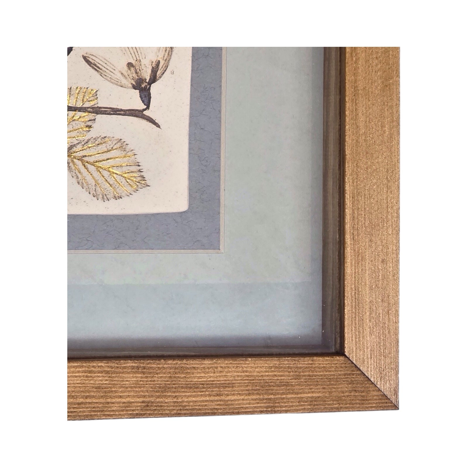 Corner of framed artwork with four botanical tiles featuring snowdrops on a light grey background in an oak frame. 