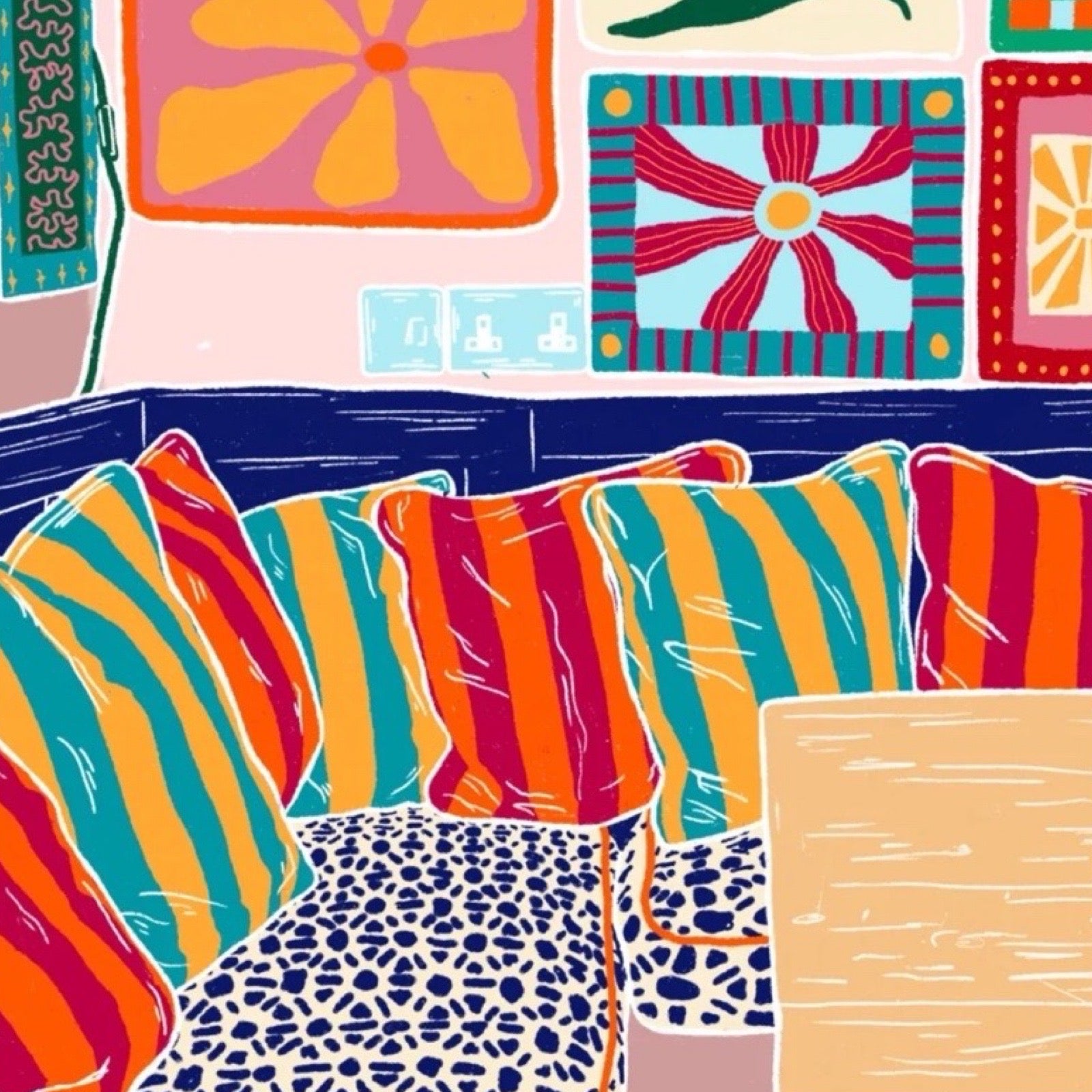 Print of a colourful sung with stripy cushions and art on the walls.