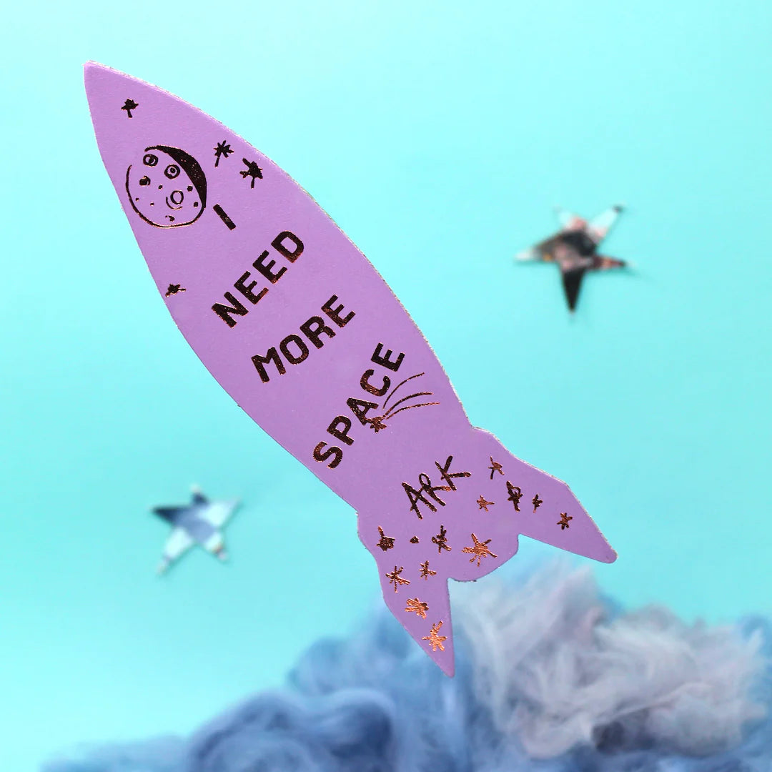 Pink rocket bookmark with 'I Need More Space' text on a blue background.