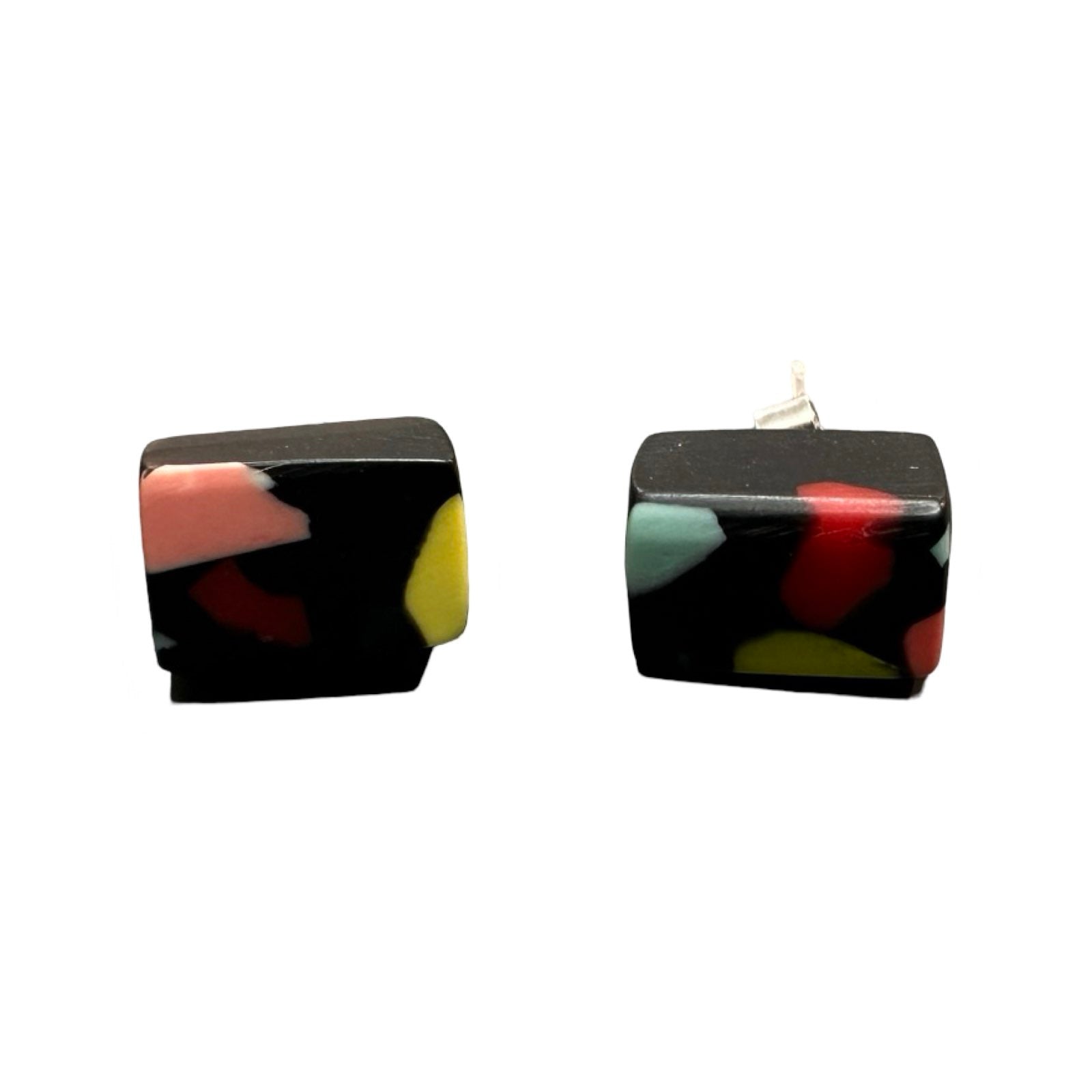 A pair of black cube-shaped stud earrings with colourful resin speckles