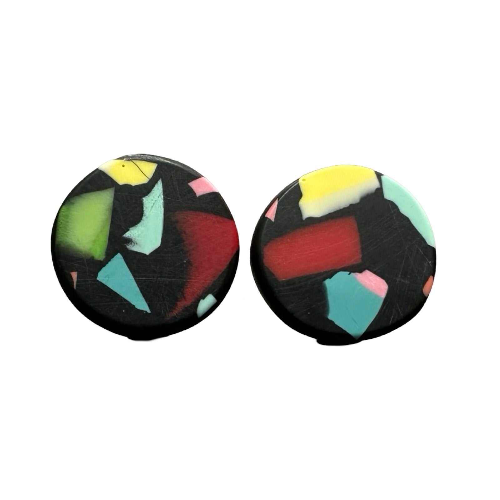 A pair of circular stud earrings with colourful speckles.