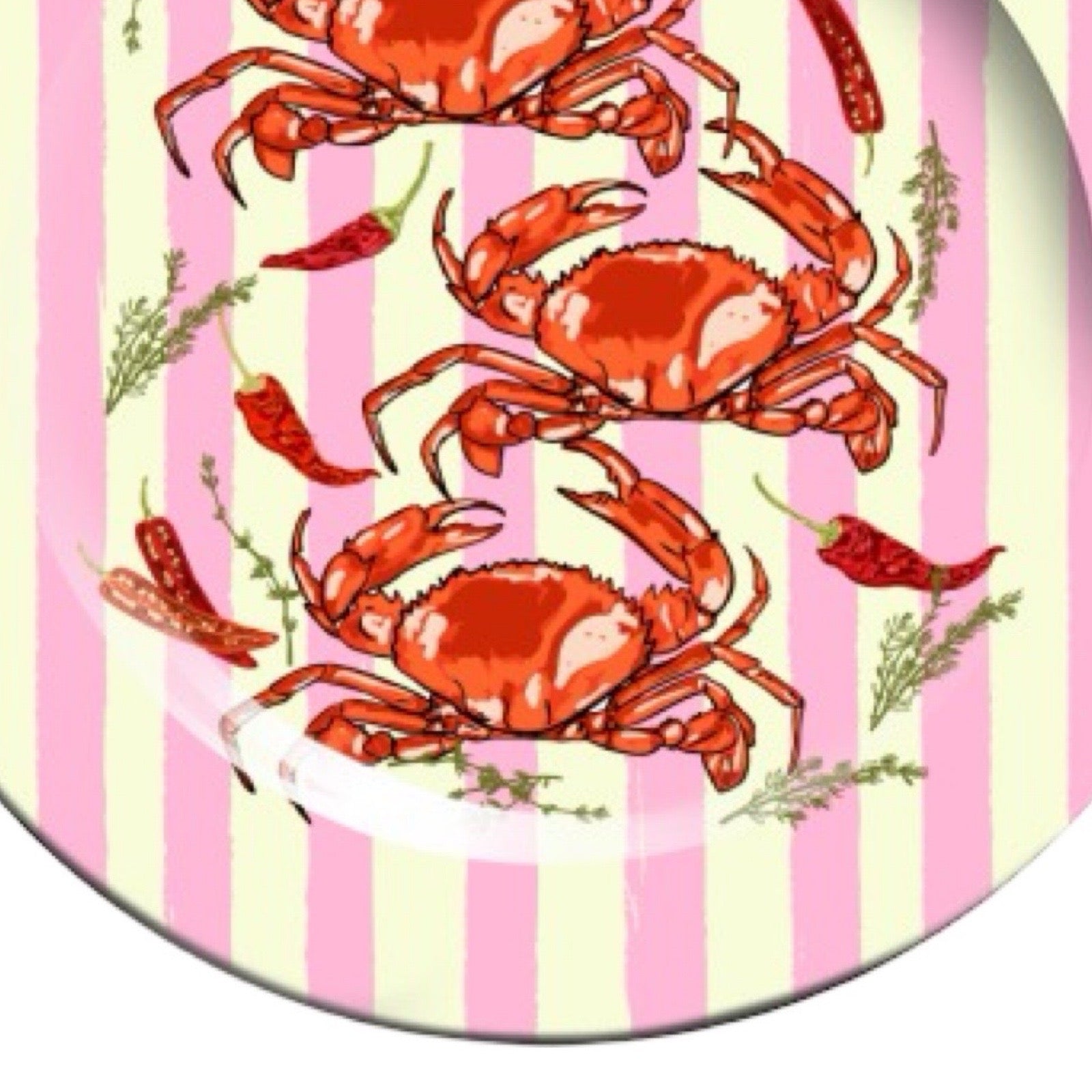 Three red crabs on a pink and white striped plate.