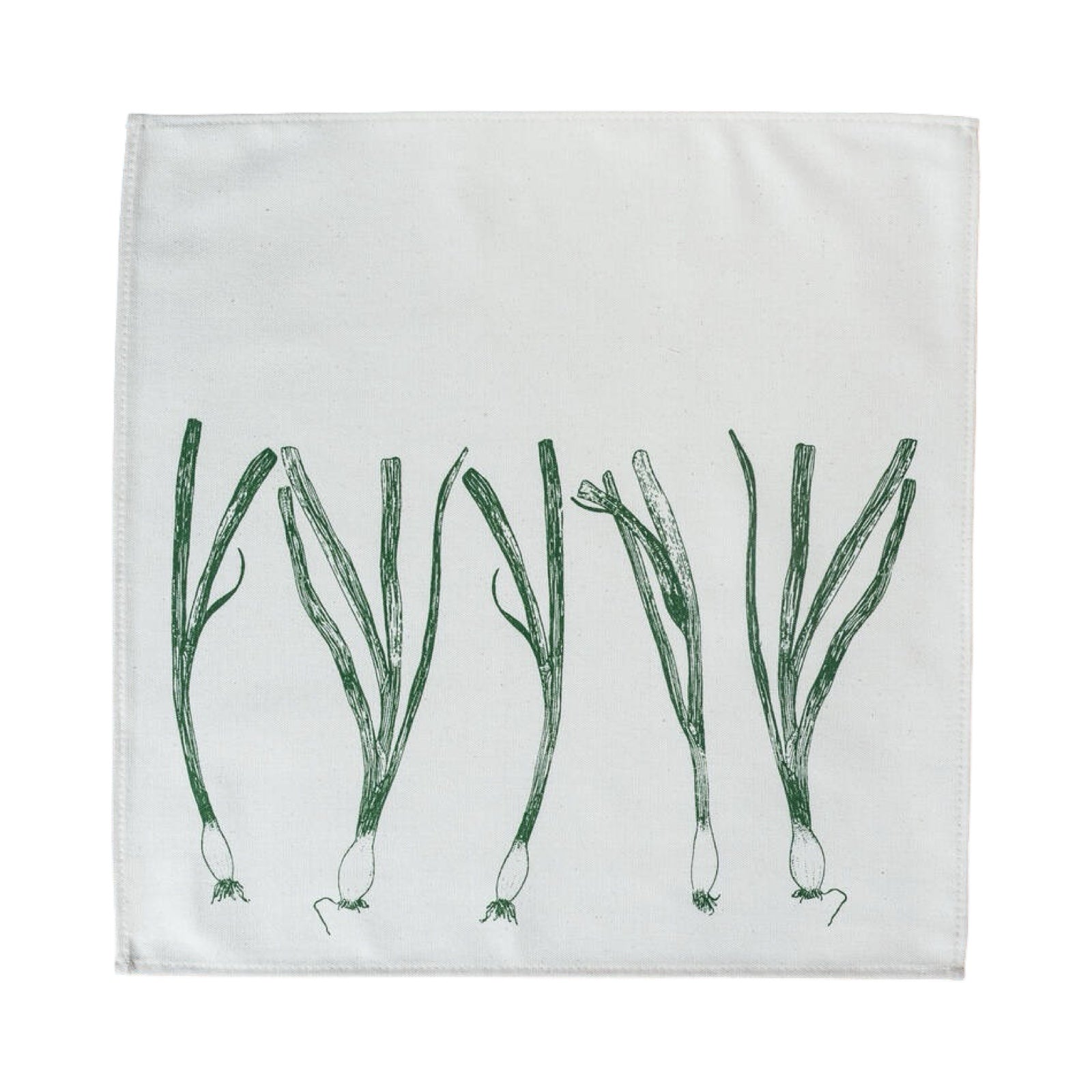 Cream cotton napkin with a green spring onion open.