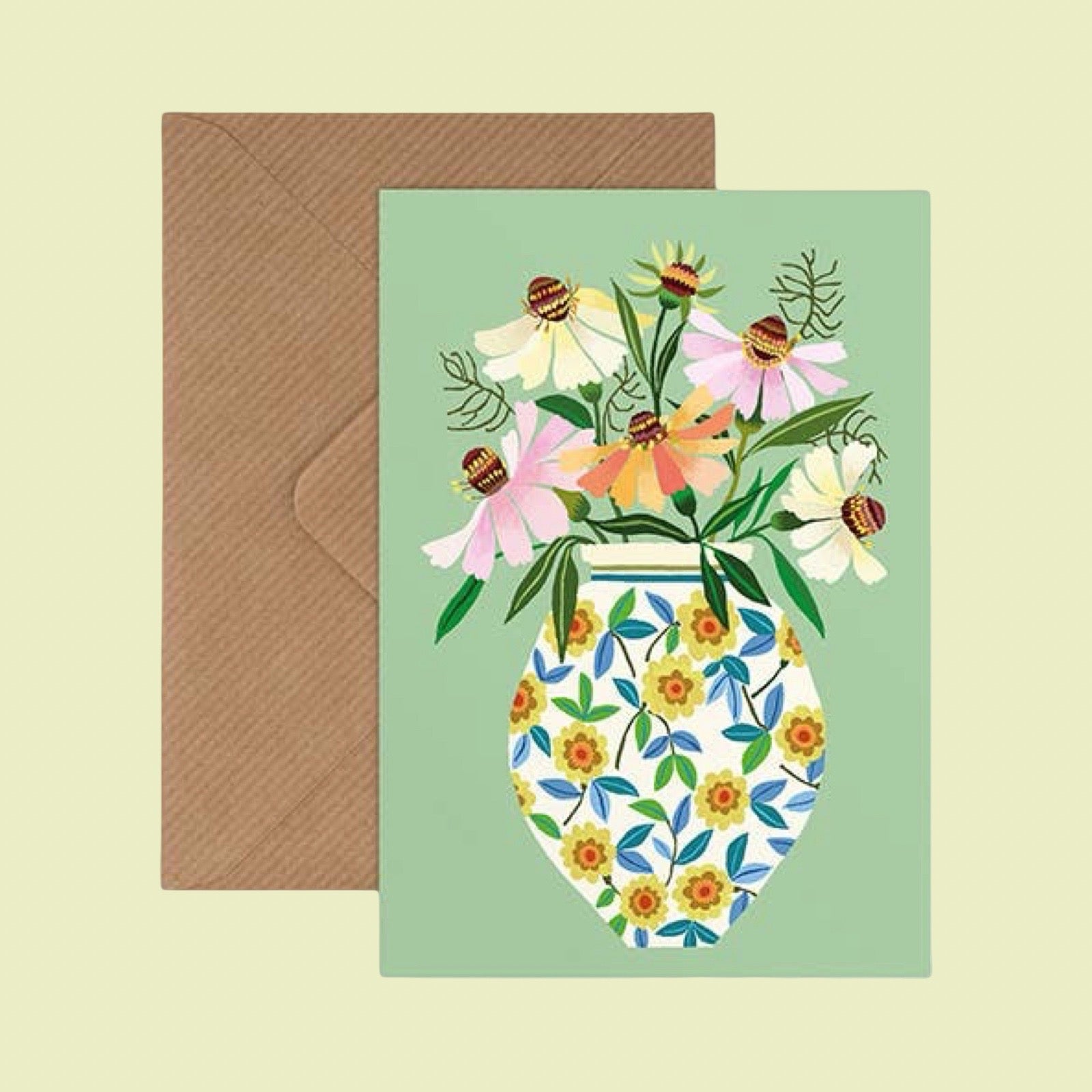 Greeting card with floral design and envelope on a light green background.