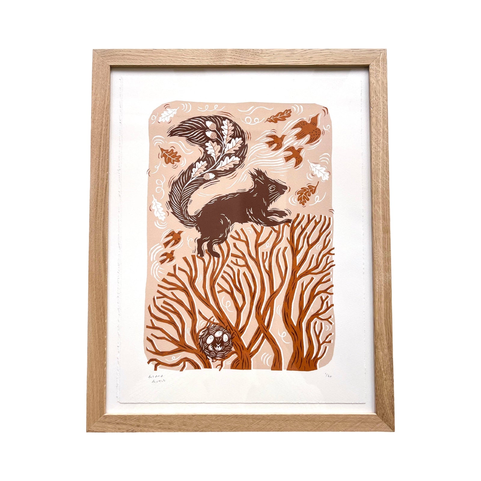 This squirrel screen print is printed in orange, red and peach. It features a squirrel playing in the treetops with a bird's nest resting below, and is printed on hand-torn, thick, satin white paper. 