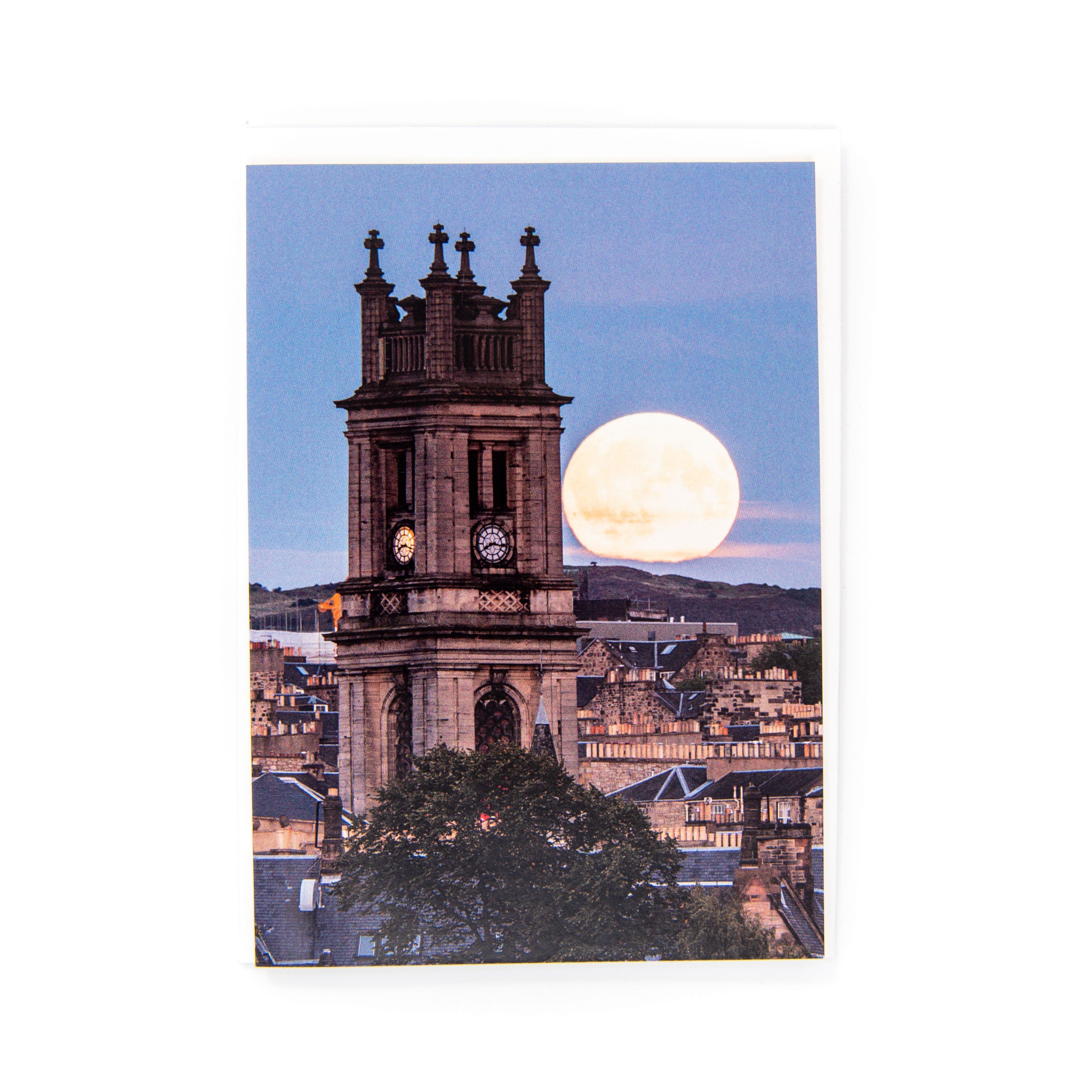 An A6 greeting card of St Stephen's Church, Edinburgh with the moon rising behind it, taken from Inverleith Park.