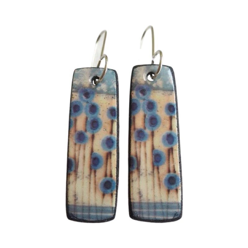 These porcelain drop earrings are made from black porcelain casting slip layered with a white decorating slip and a ceramic decal.