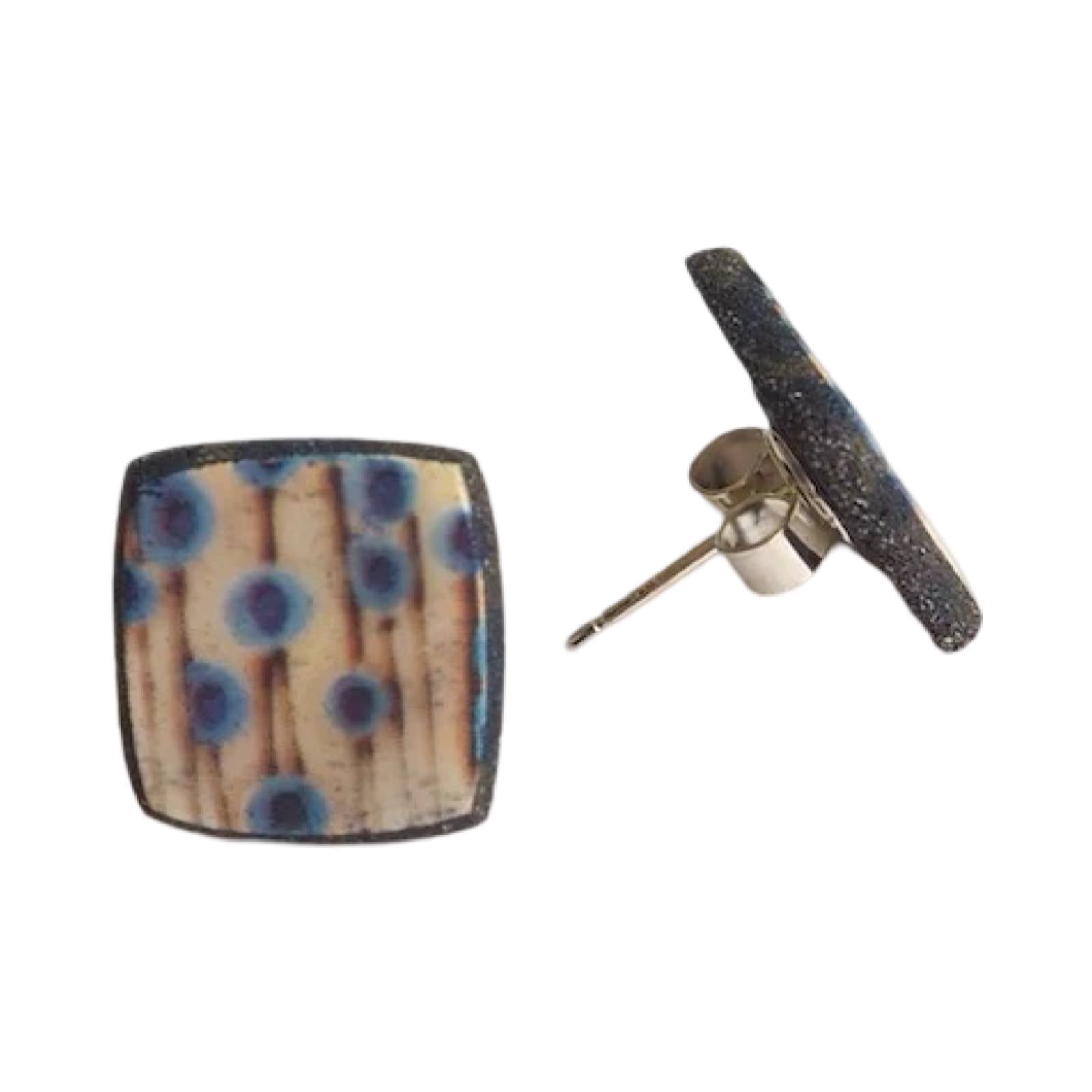 These porcelain square stud earrings are made from black porcelain casting slip layered with a white decorating slip and a ceramic decal.