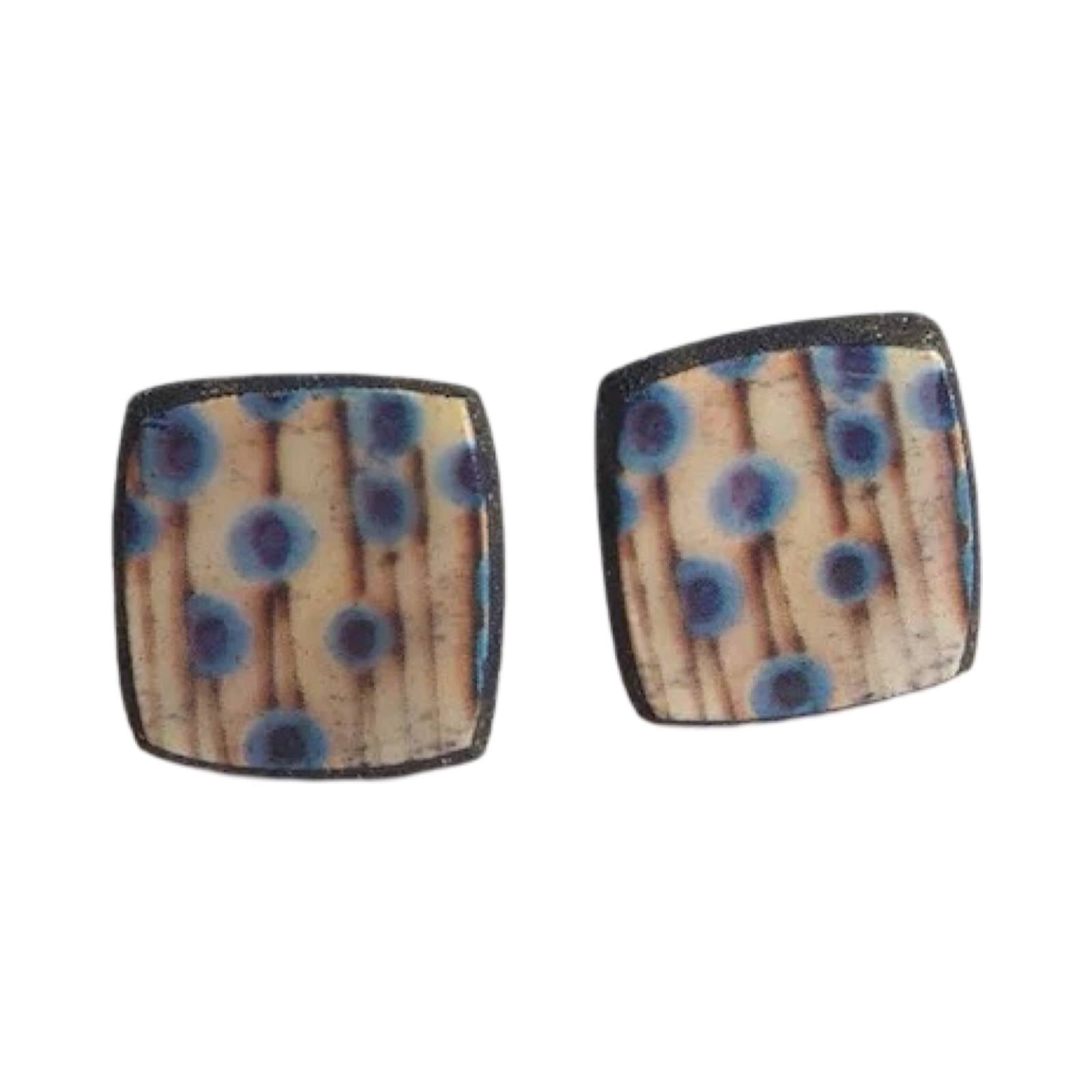 These porcelain square stud earrings are made from black porcelain casting slip layered with a white decorating slip and a ceramic decal.