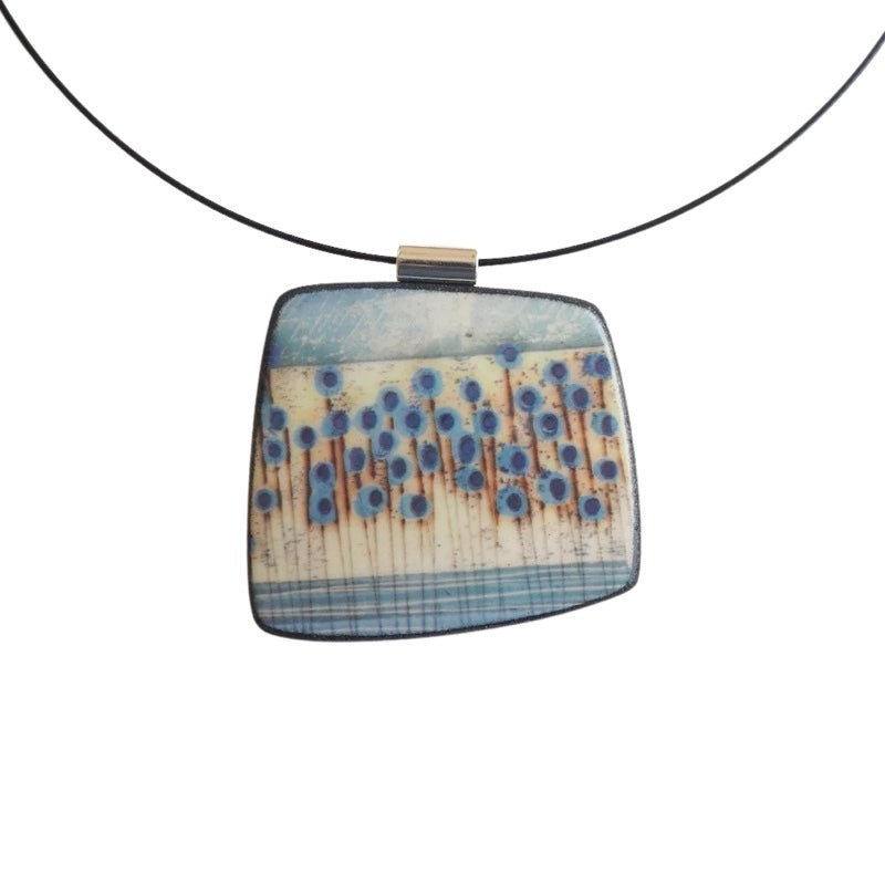 This pendent necklace is made from black porcelain casting slip layered with a white decorating slip and a ceramic decal, it is a wearable piece of art! The brooch features a turquoise, grey, black and cream abstract floral stem pattern, inspired by nature.