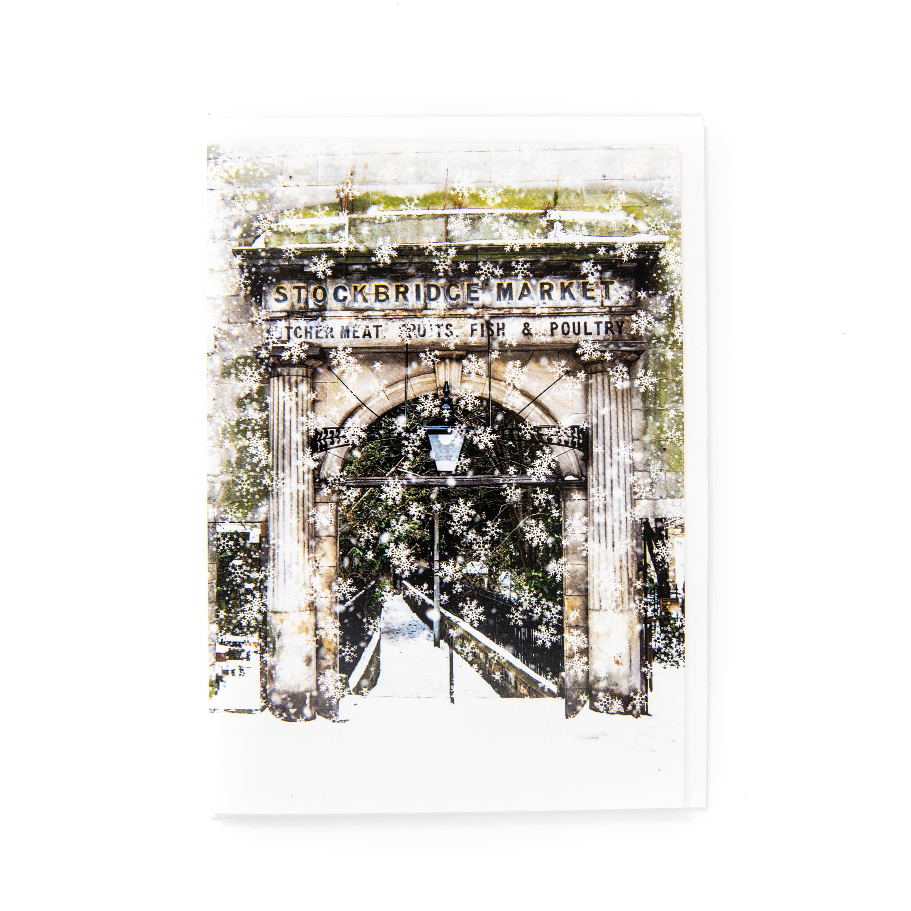 A greetings card featuring the Stockbridge Market Arch with snowflakes, printed on a white background.