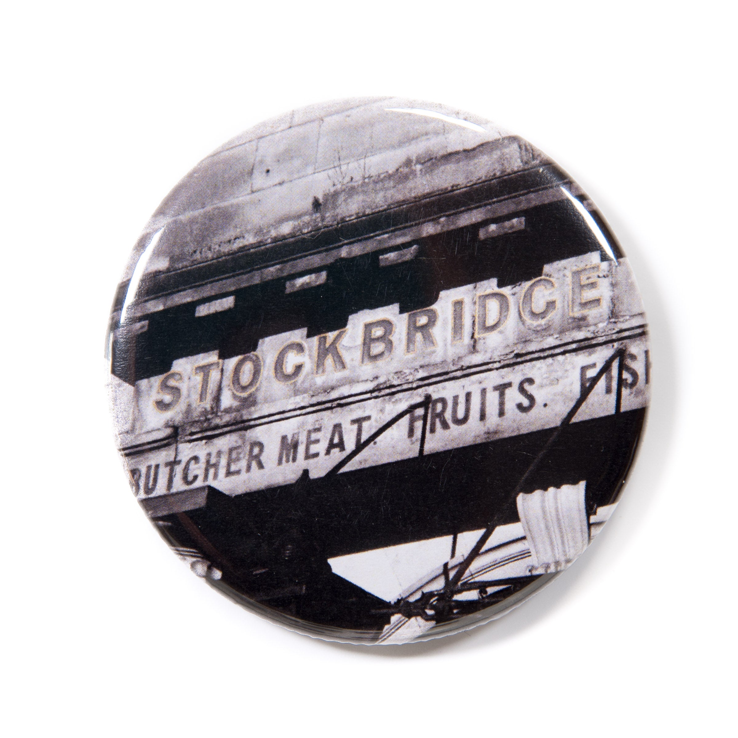 A round magnet with 'Stockbridge' text and black and white design
