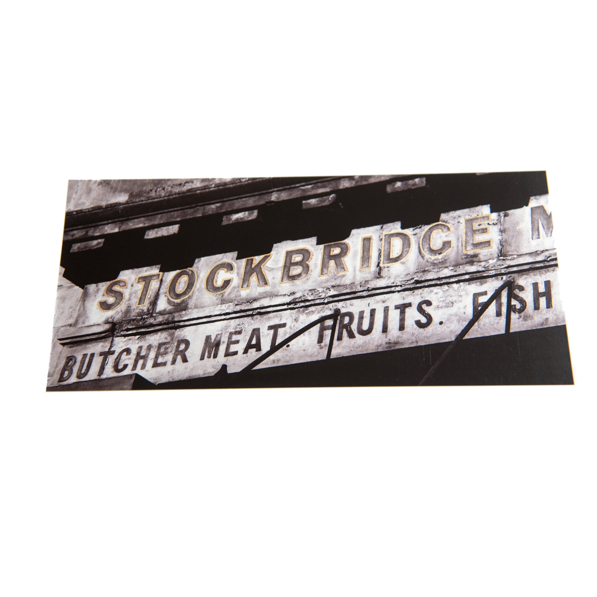 A close up of the Stockbridge Market Arch sign on a card. 