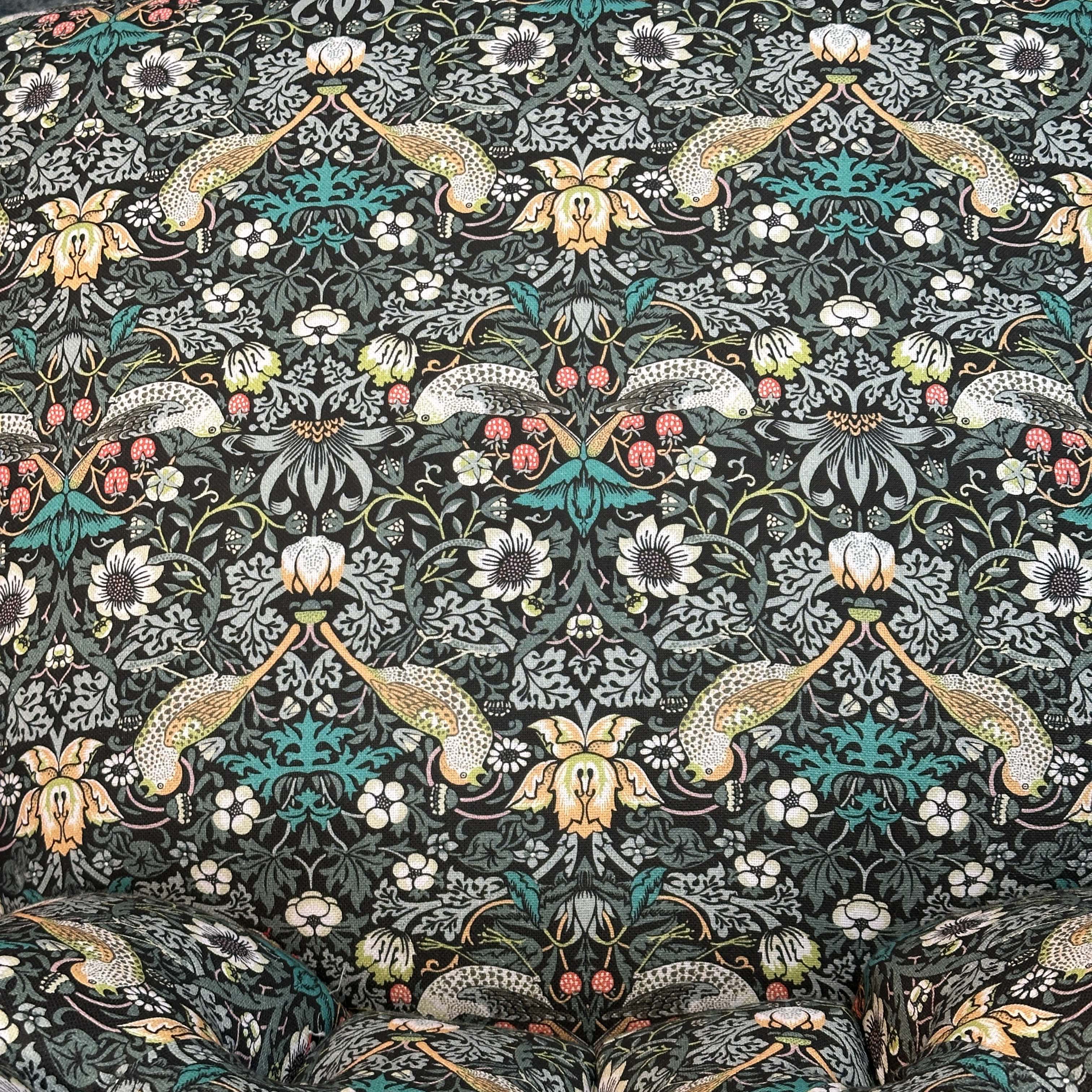 Decorative fabric pattern with flowers and birds on a dark background.