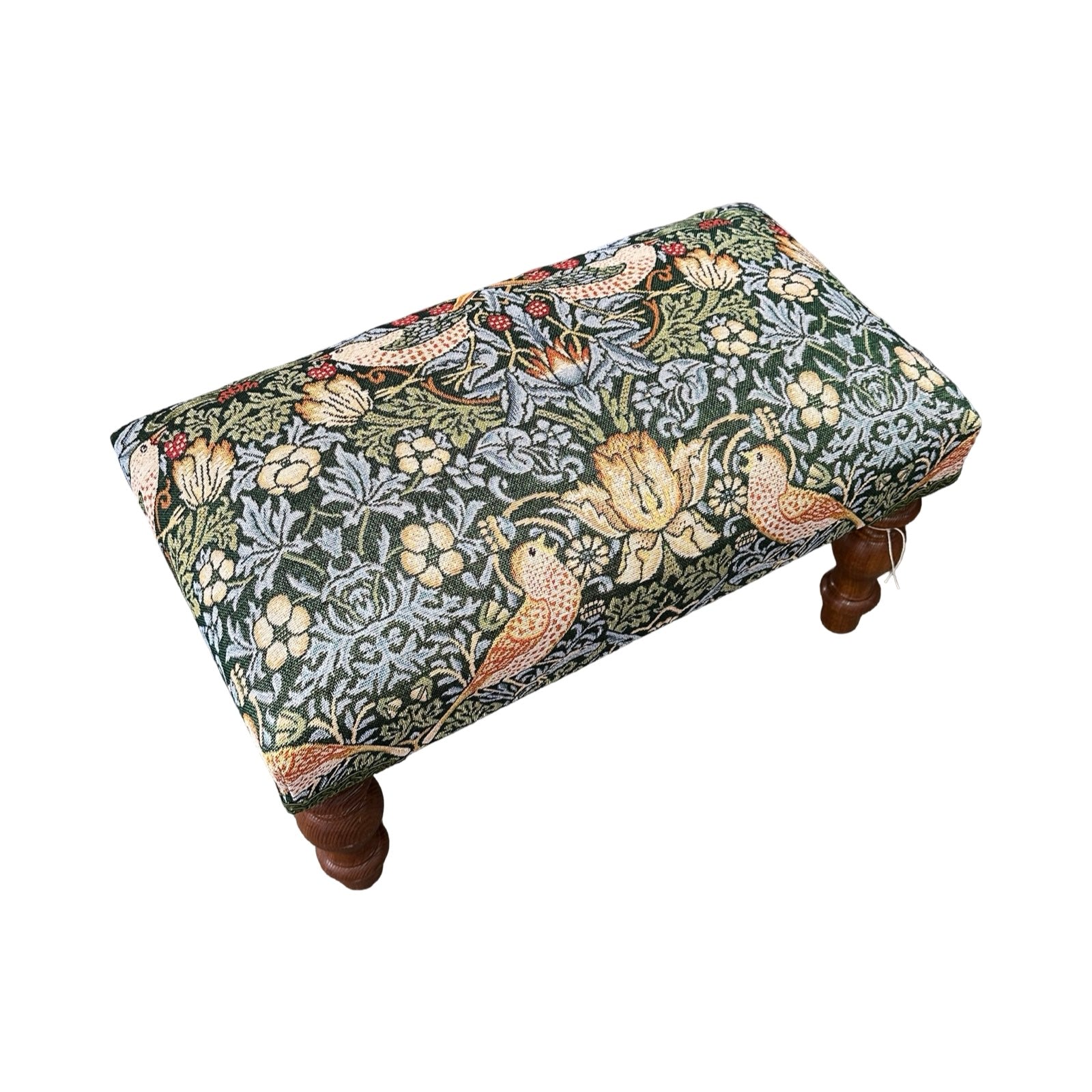 Footstool with floral pattern on a white background.