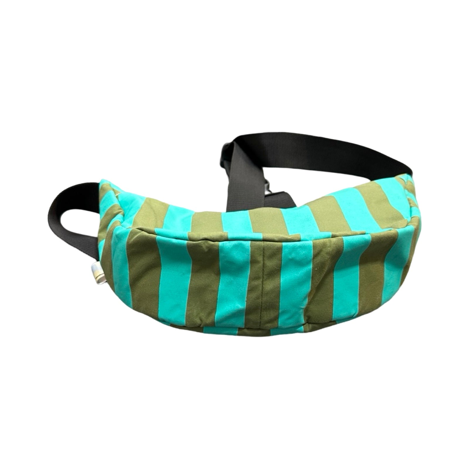 The base of a green and turquoise striped sling bag with a black adjustable strap.