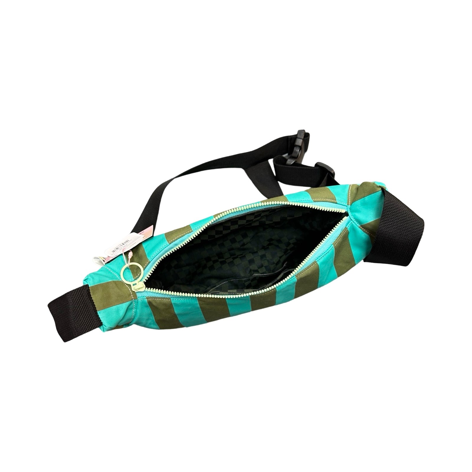 A green and turquoise striped sling bag open showing grey and black checked lining fabric.