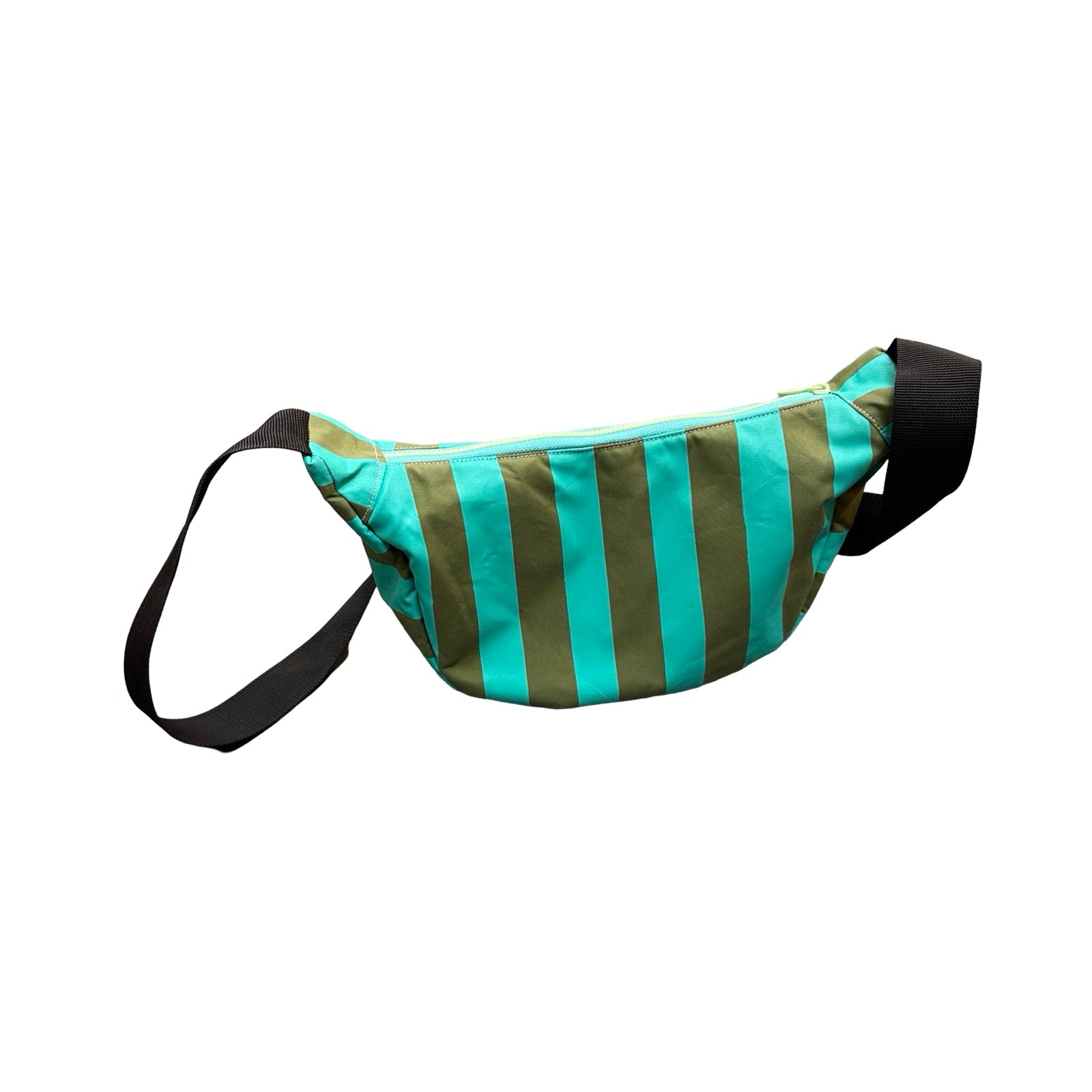 A green and turquoise striped sling bag with a black adjustable strap.