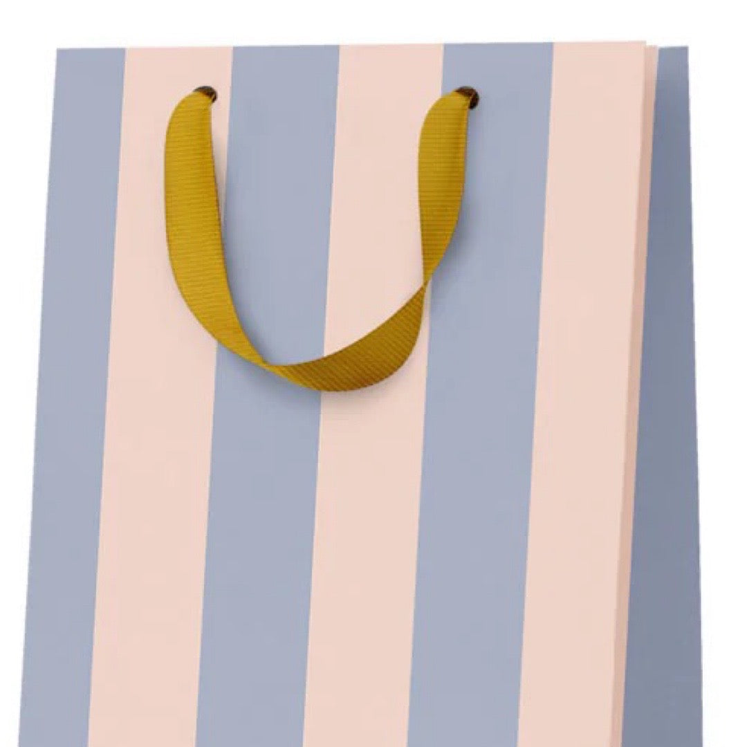Striped gift bag with a yellow handle on a white background.