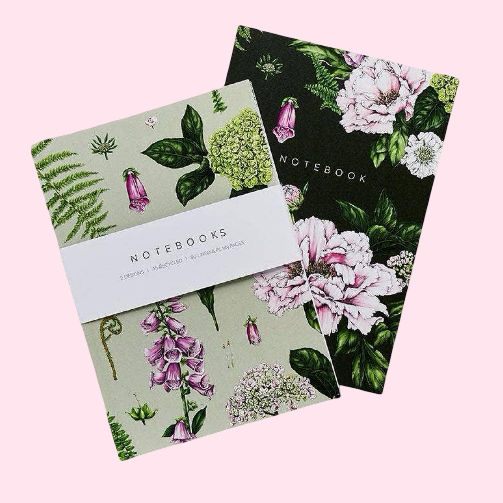 Two notebooks with floral designs on a pink background.