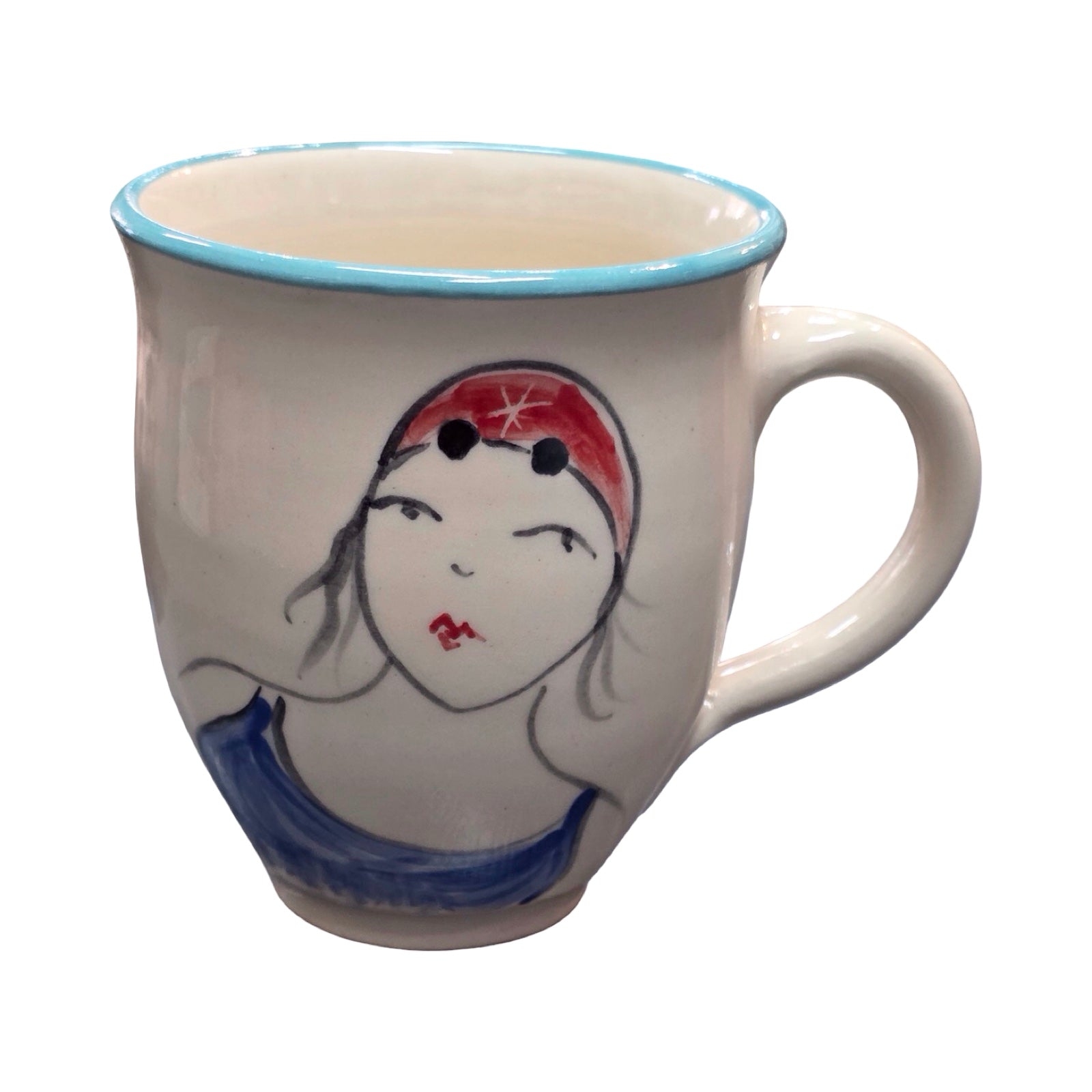 Ceramic mug with a face design on a white background.
