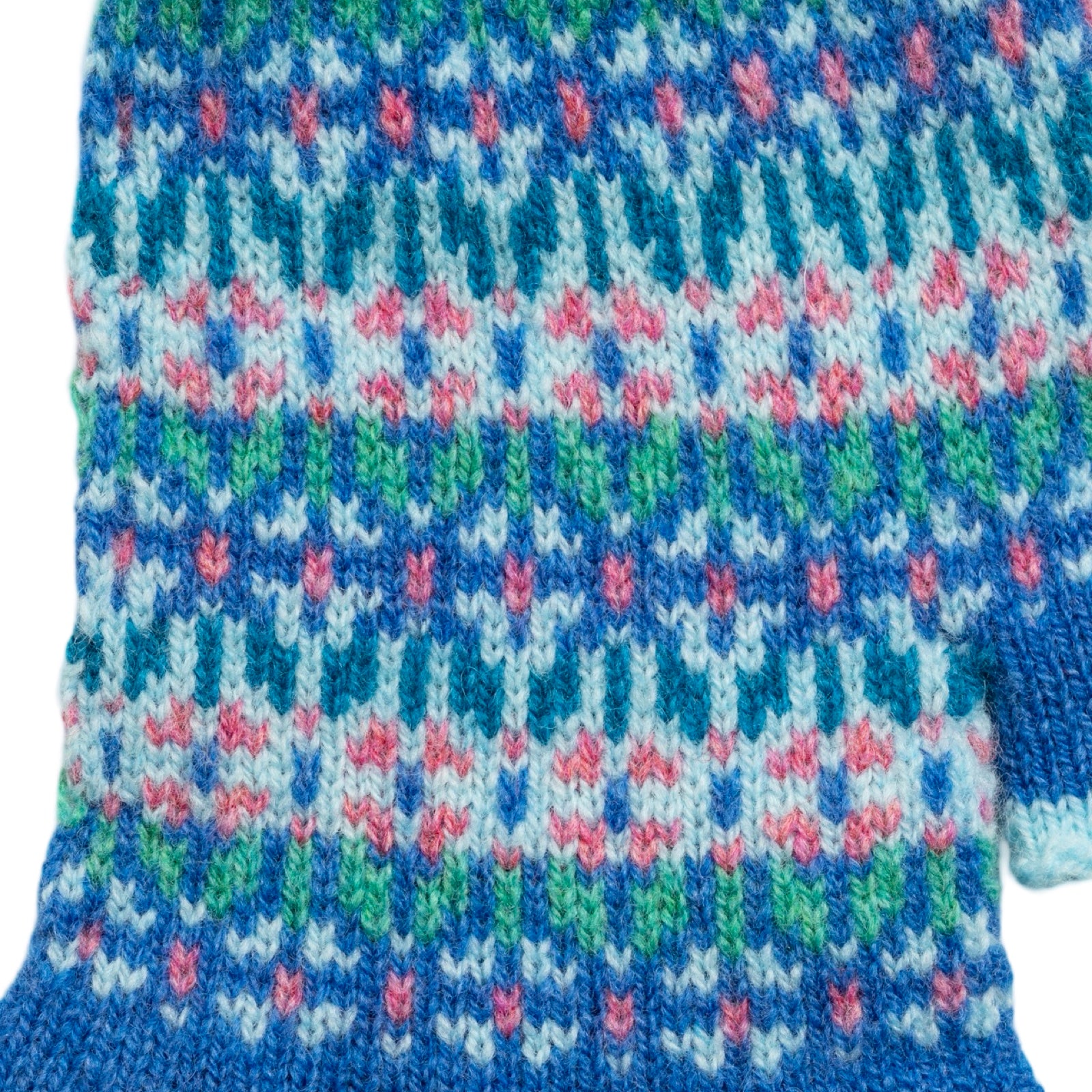 Close-up of a knitted fabric with a colorful pattern on a white background.