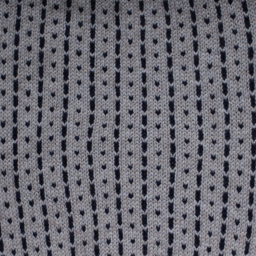 A cosy 100% lambswool knitted snood in a light brown/grey with black dashes.