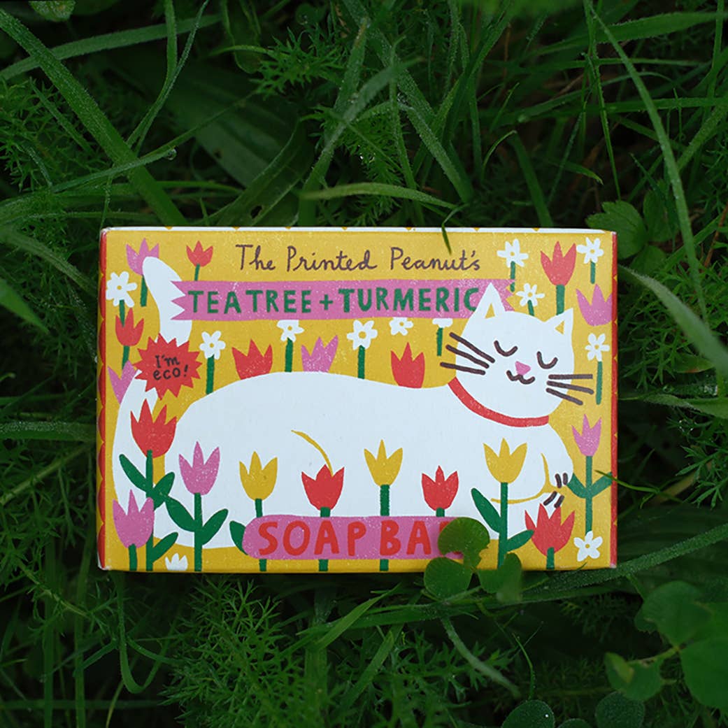 Soap bar packaging with a cat illustration on a grass background.