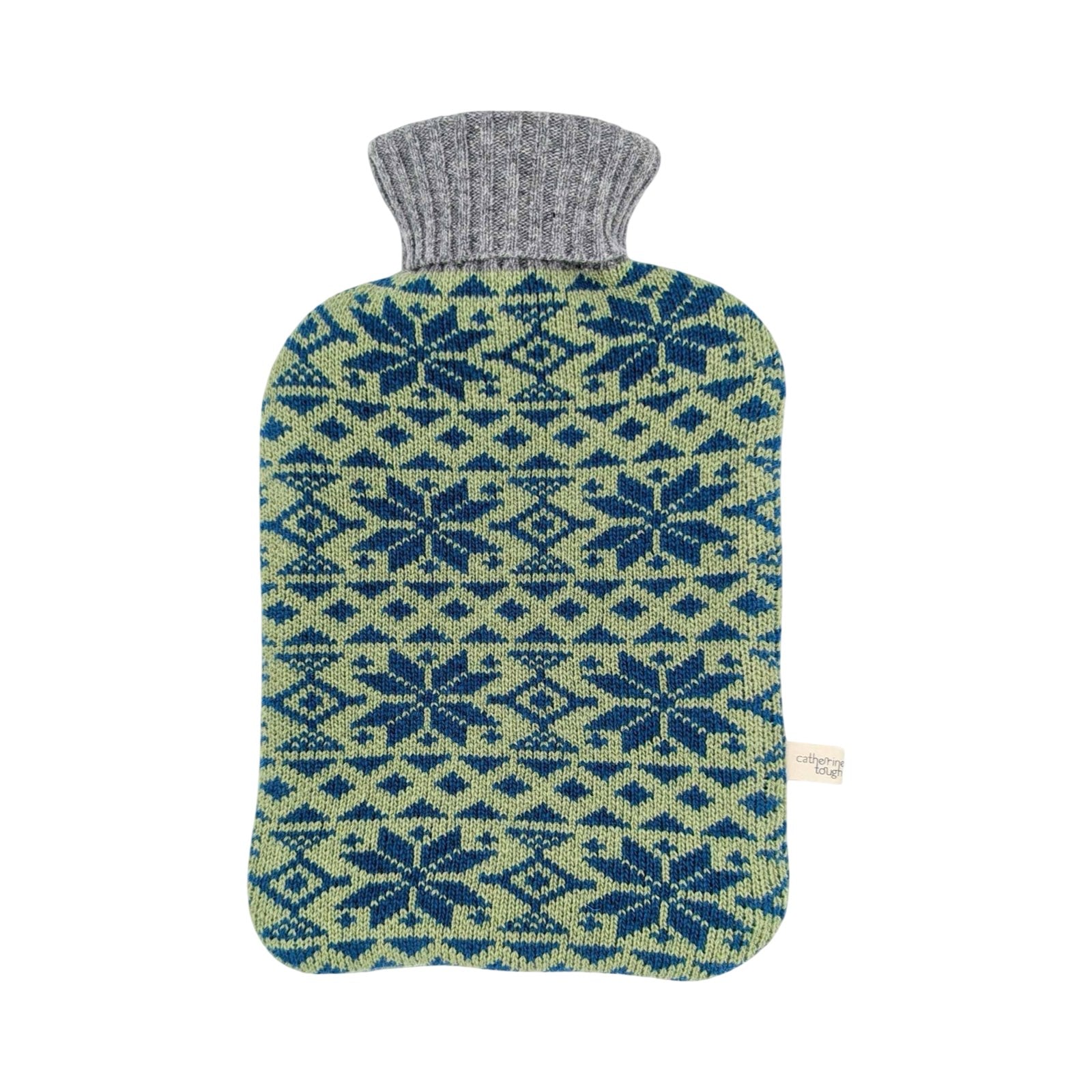 A knitted hot water bottle cover with a gray ribbed neck and a blue and sage green Nordic snowflake pattern, shown on a plain white background.
