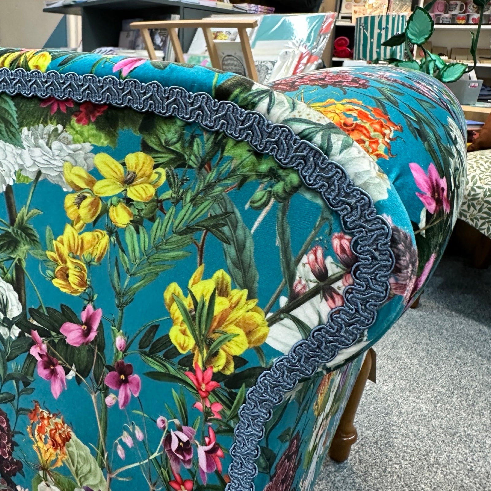 Floral-patterned chair with colourful flowers and leaves.