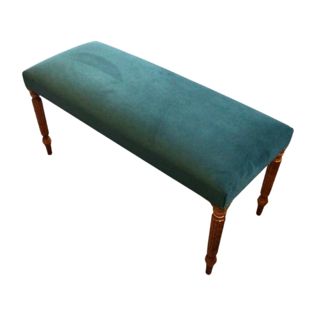 A rectangular velvet bench with mahogany stained legs in a teal colour design.
