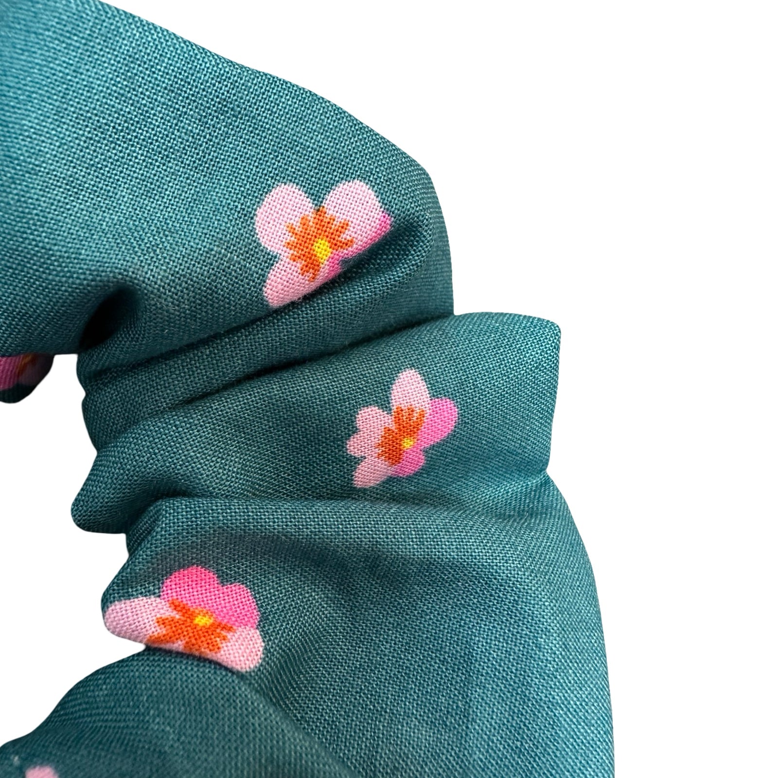This teal handmade hair scrunchie is made from 100% cotton fabric with pink violets.