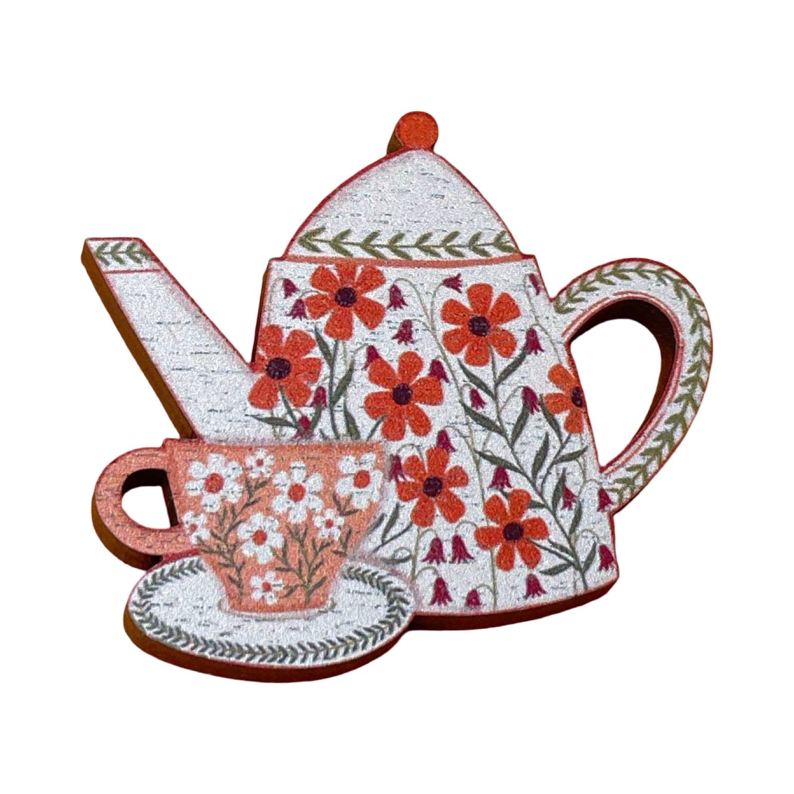 A decorative teapot and matching teacup and saucer brooch, decorated with red-orange flowers, green leaves, and brown outlines, shown on a plain white background.