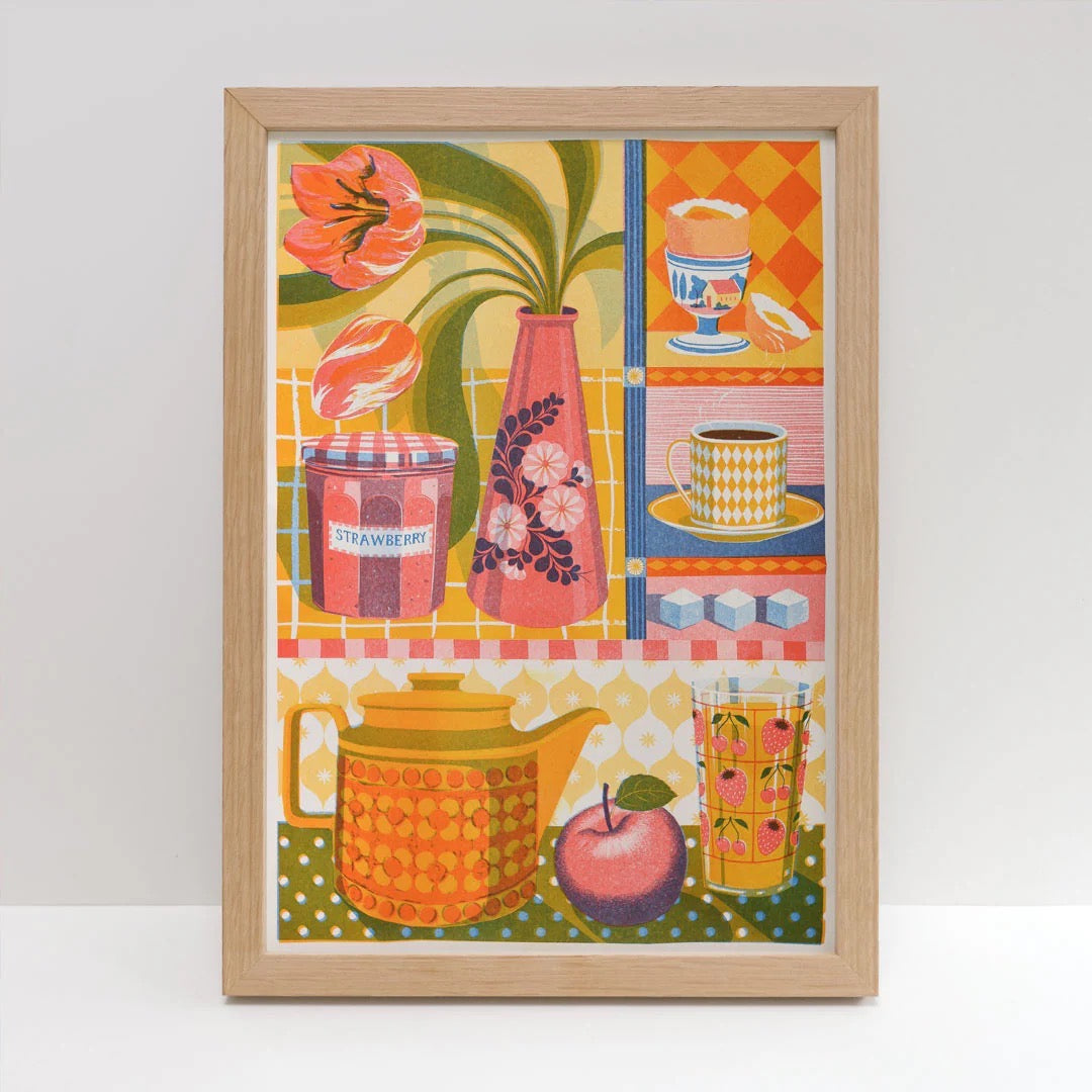 Framed colourful artwork with kitchen-themed illustrations on a white background.
