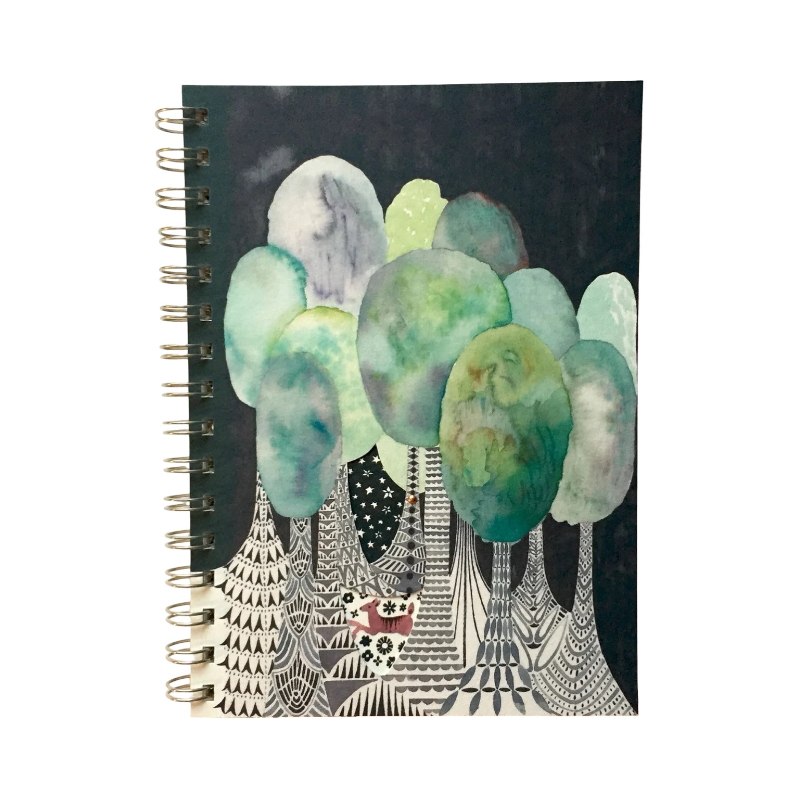 Notebook with artistic design of trees and a deer on a black background.