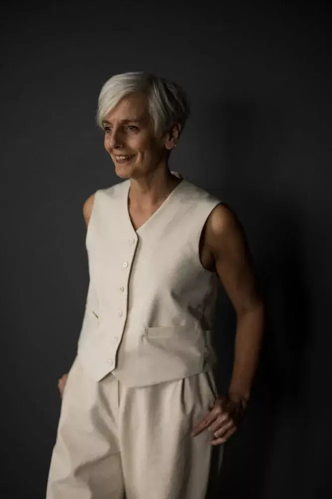 Sewing pattern for a waistcoat with a structured, boxy fit, two welt pockets and a simple stitched belt at the back.