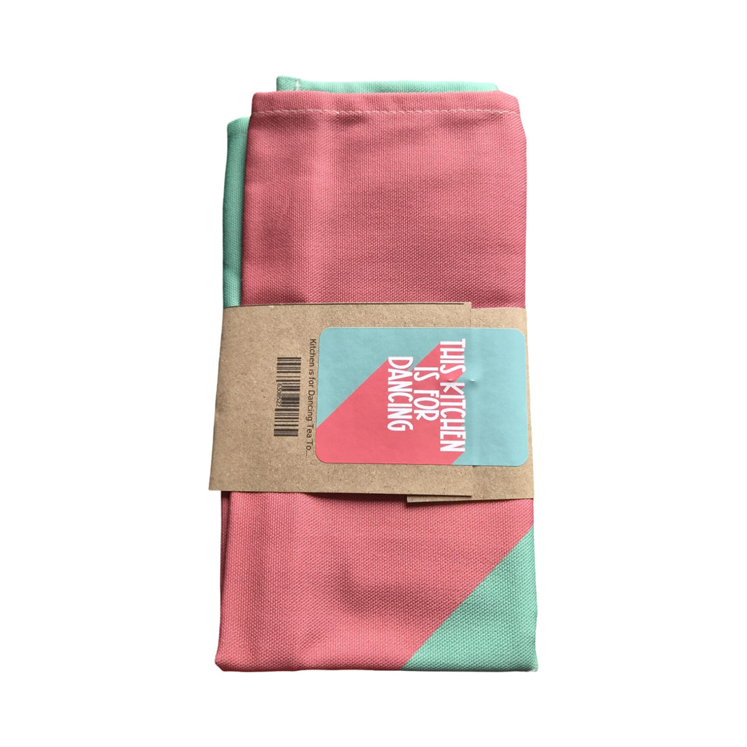 Folded pink and green fabric with a label on a white background